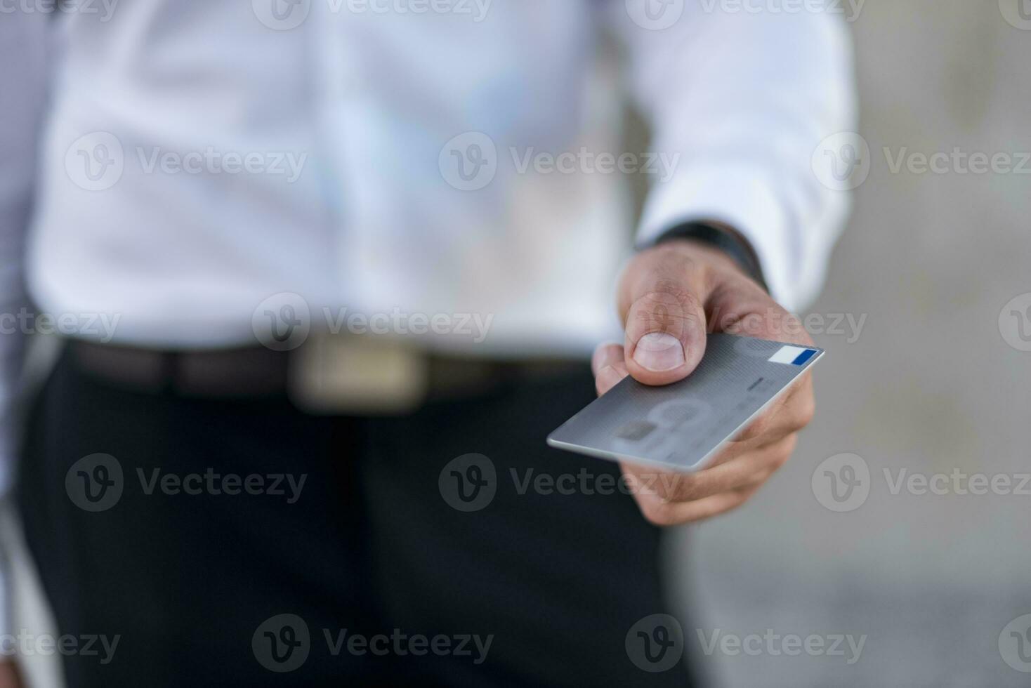 Close-up of businessman holding credit card photo