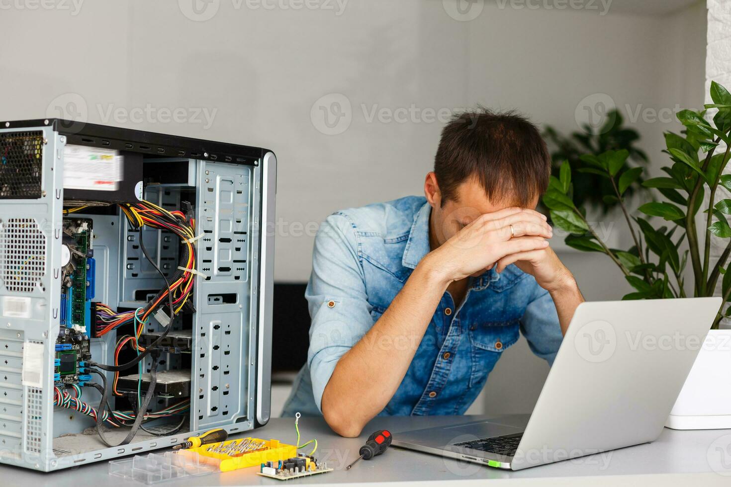 Computer engineer working on broken console in his office photo