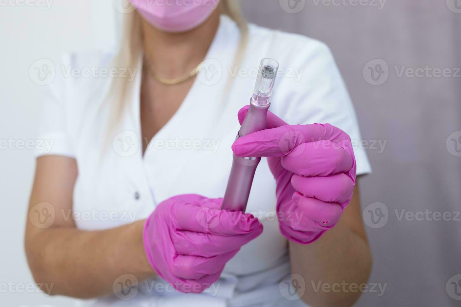 Mesotherapy And Microneedling Treatment. Closeup Real Female Dermatologist Holds Electric Microneedling Pen For Invasive Cosmetic Procedure Using Thin Needles. Microdermabrasion, Horizontal Plane photo