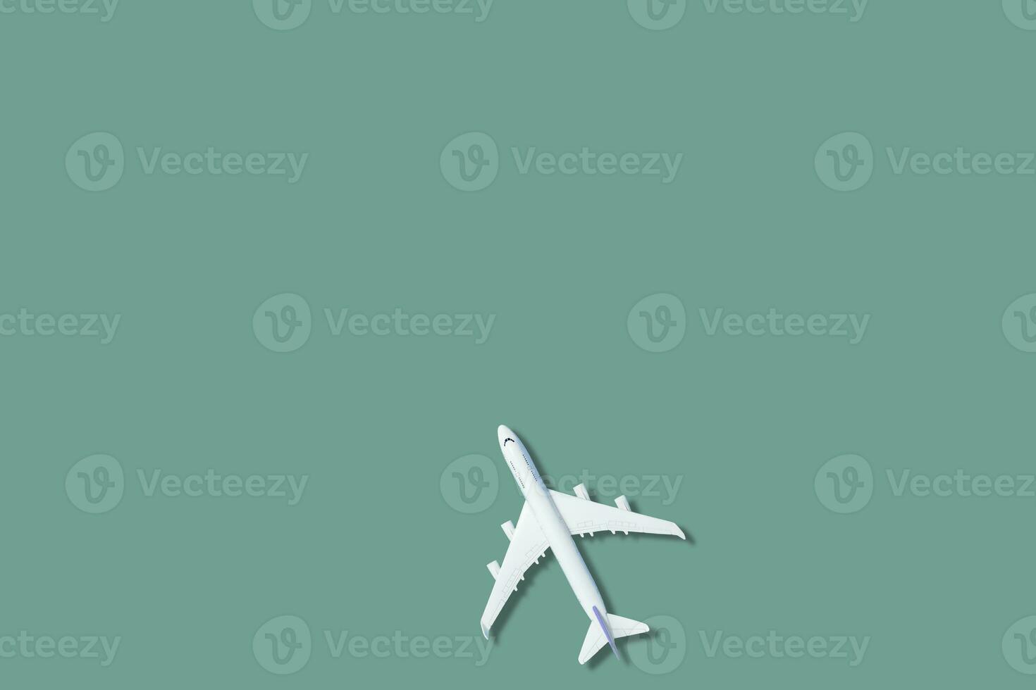 white airplane on a blue background, top view photo