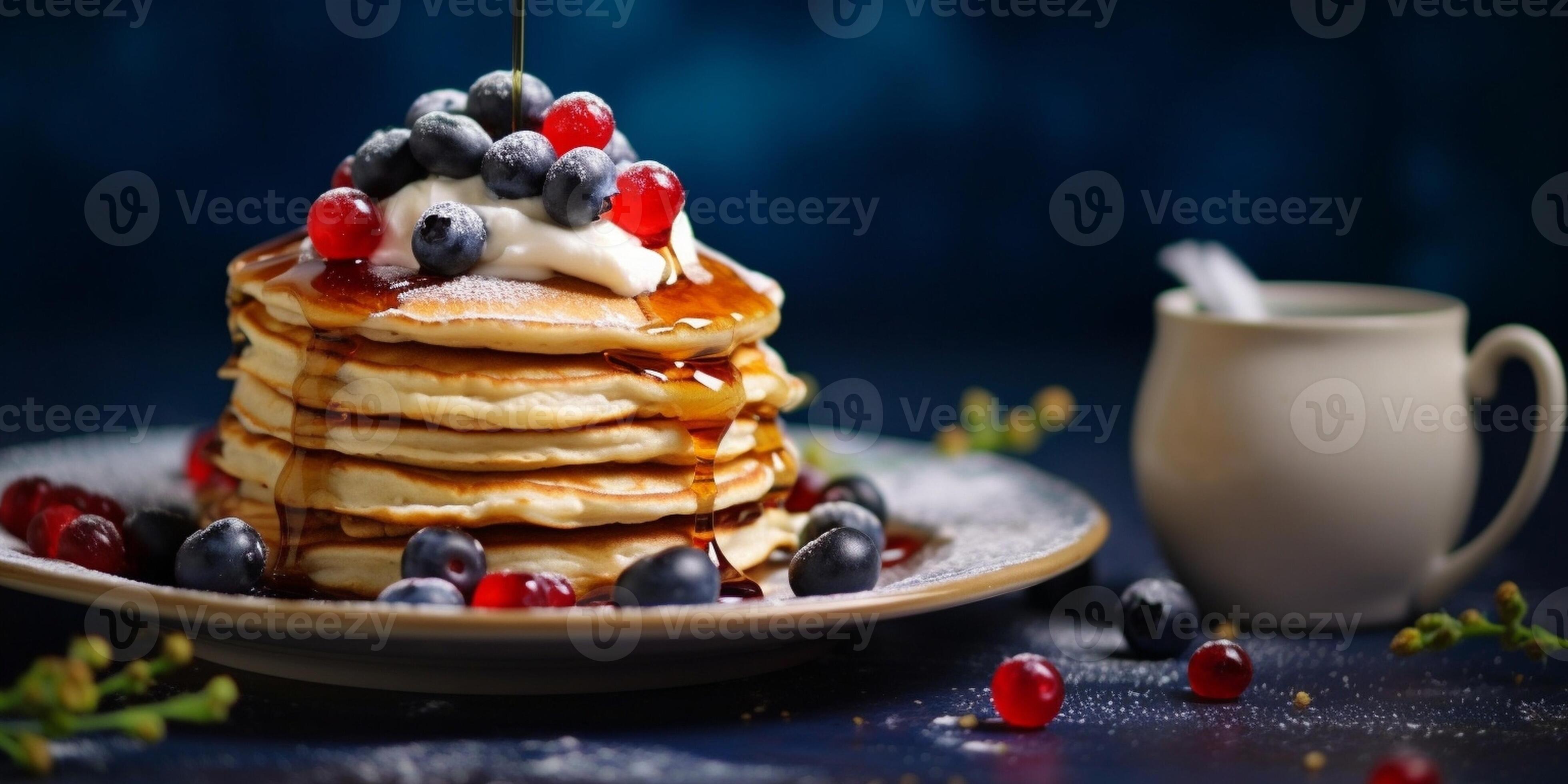 Cottage cheese pancakes or syrniki with blueberry and strawberries on black plate closeup view