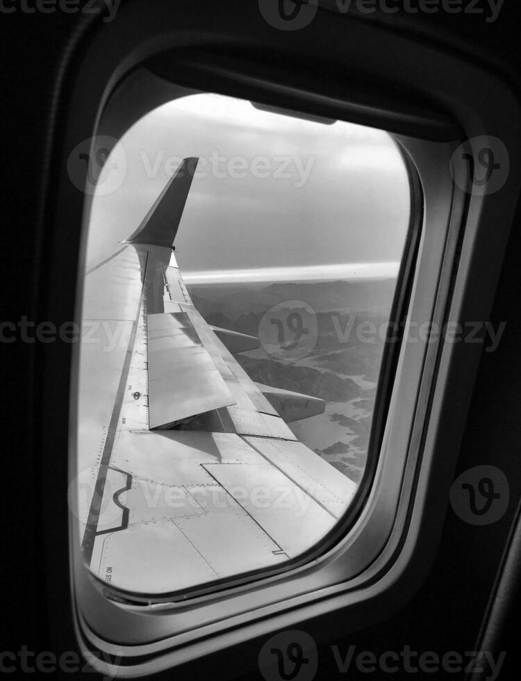 Beautiful view from airplane window, large wing of aircraft shows casement photo