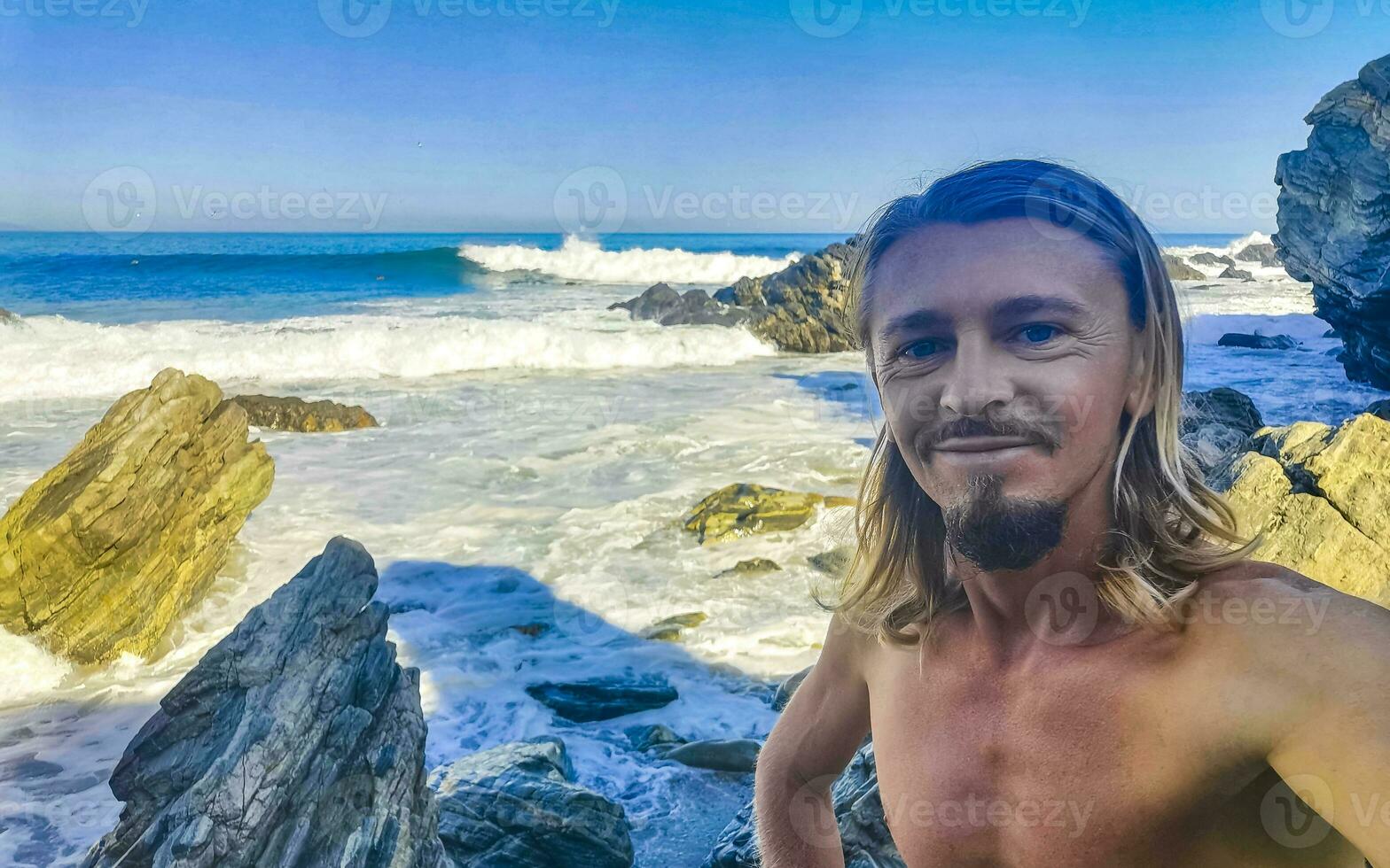 Selfie with rocks cliffs view waves beach Puerto Escondido Mexico. photo