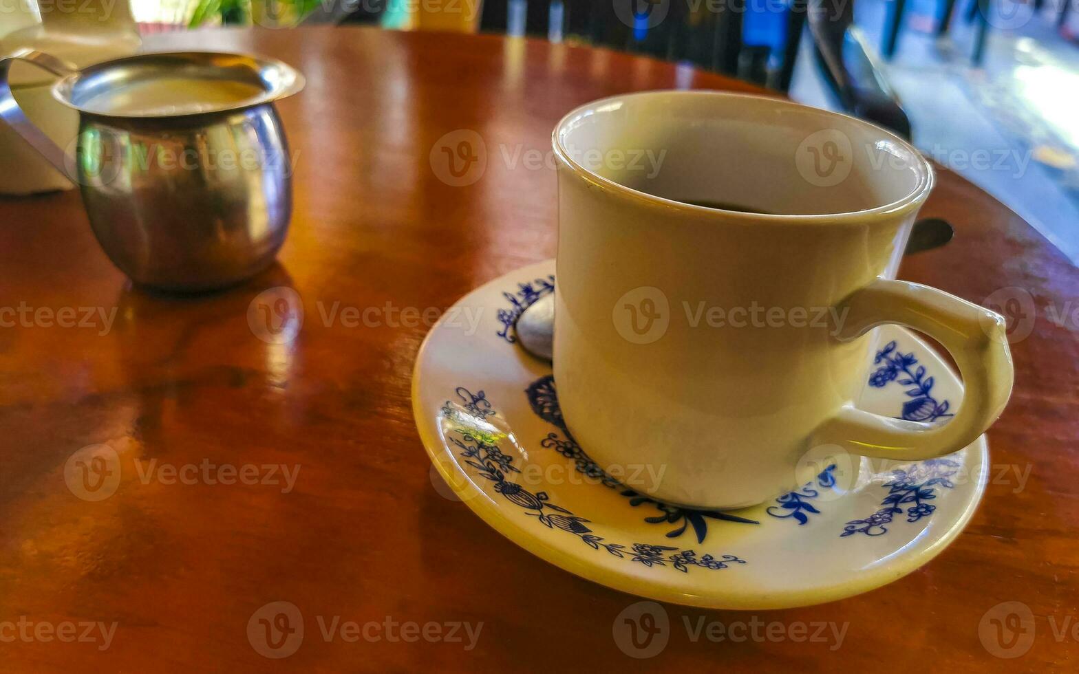 Blue white cup pot with black coffee wooden table Mexico. photo