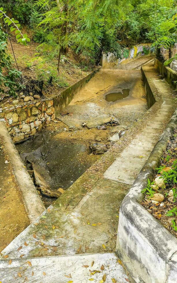 Open sewerage system in the tropical jungle mountains Mexico. photo