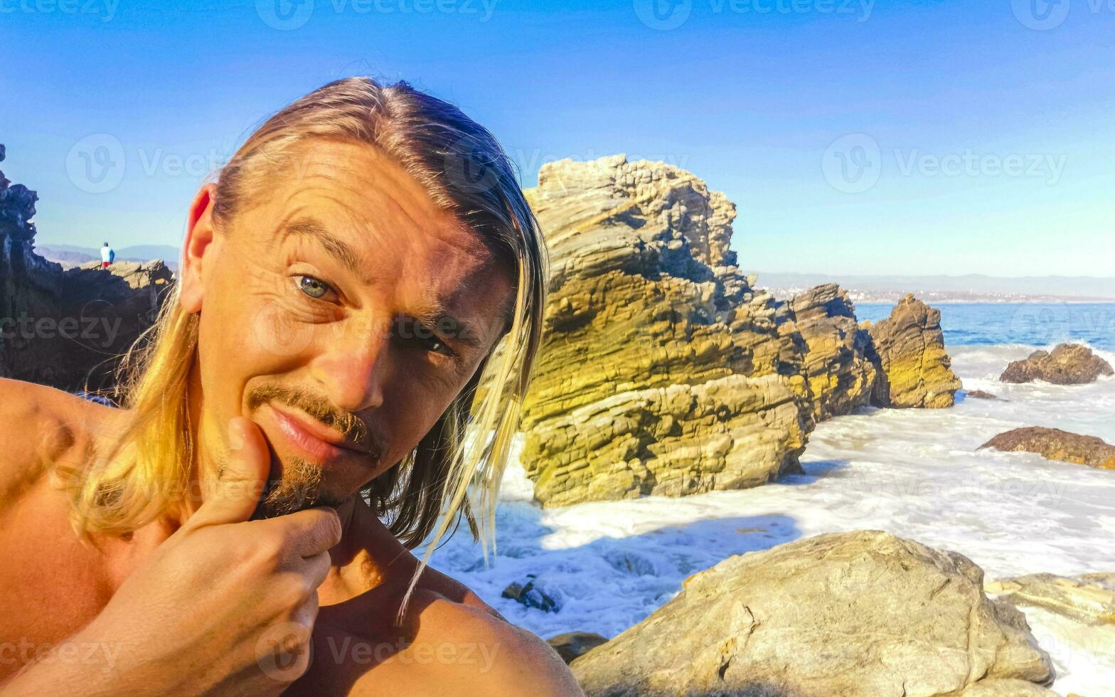 Selfie with rocks cliffs view waves beach Puerto Escondido Mexico. photo