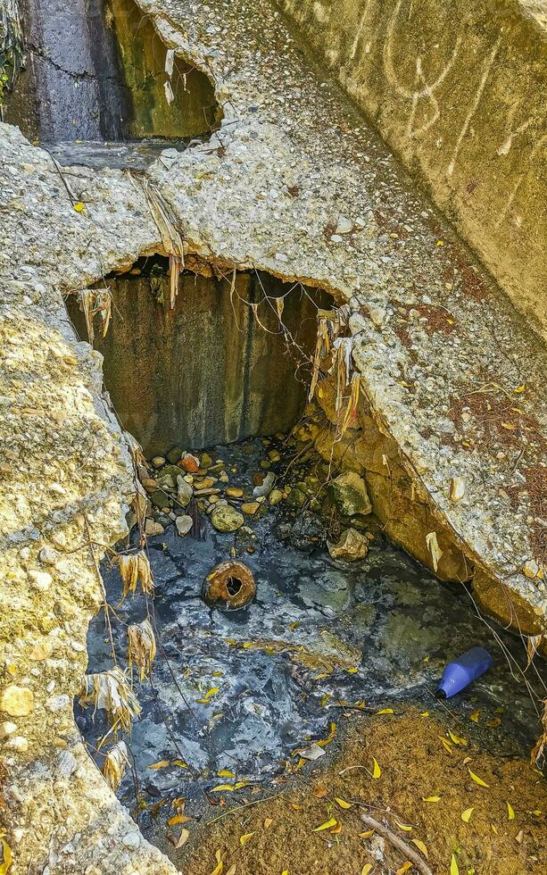 Open sewerage system in the tropical jungle mountains Mexico. photo