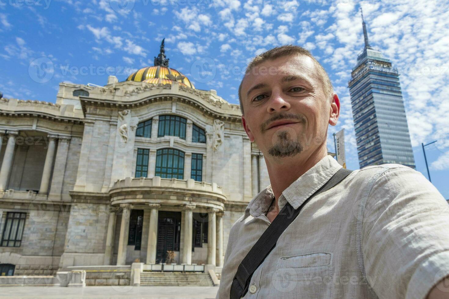 Man with selfie at fine arts architectural masterpiece Mexico City. photo