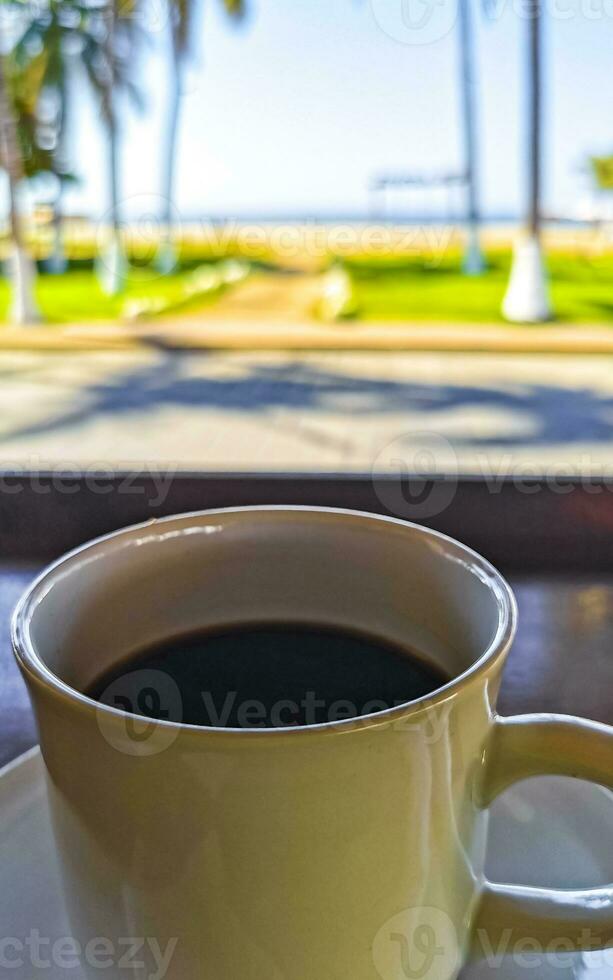 Cup of americano black coffee in restaurant Mexico. photo