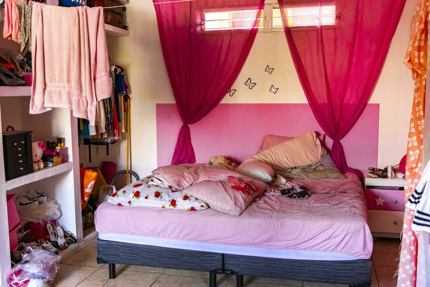 Playa del Carmen Quintana Roo Mexico 2021 Simple pink small apartment hotel room with bed table Mexico. photo