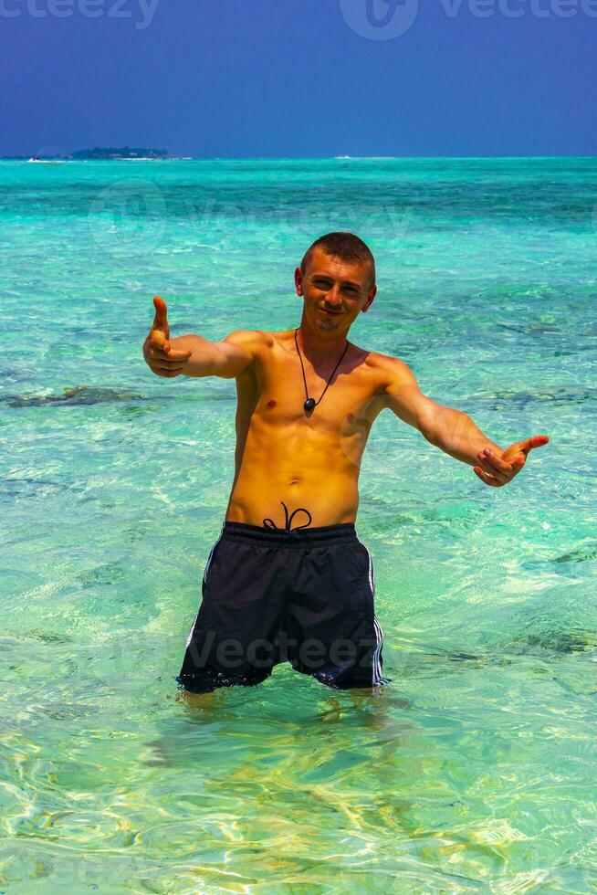 Male model tourist on island Madivaru Finolhu Rasdhoo Atoll Maldives. photo