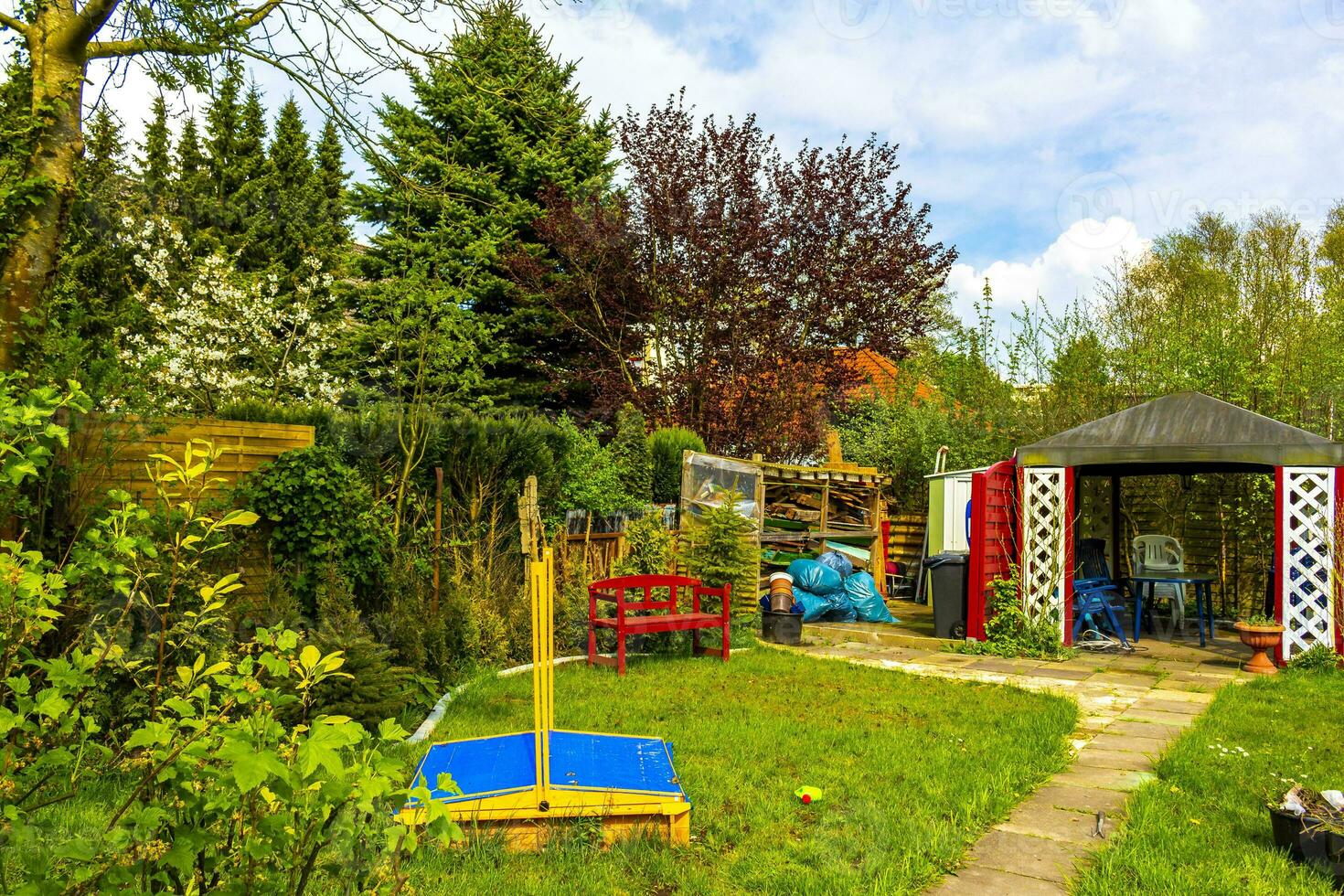 Green garden with red garden house in norwegian style Germany. photo