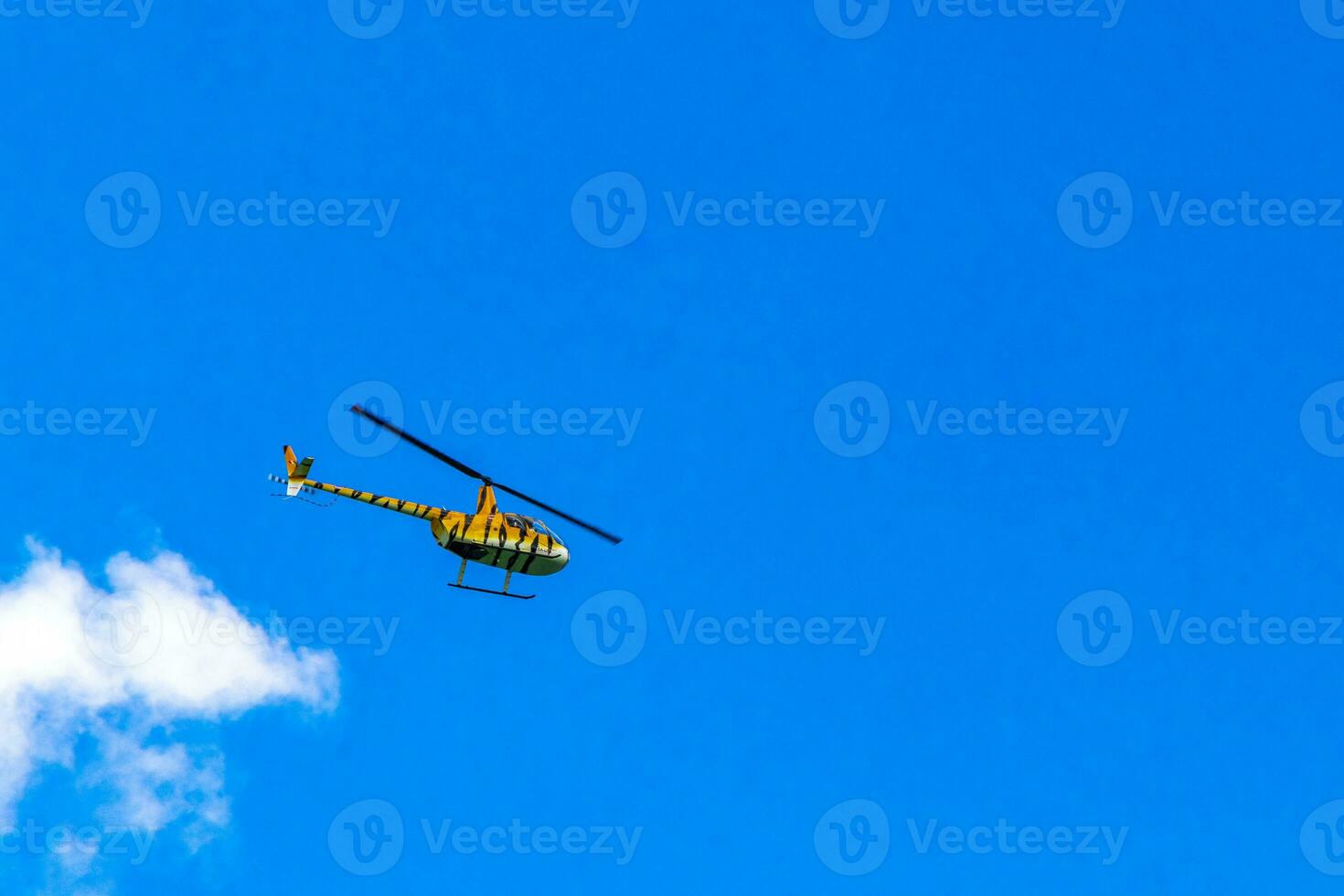Tourist helicopter flies over the Caribbean Sea in Mexico. photo