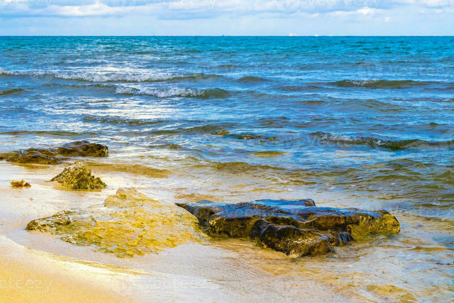 Stones rocks corals turquoise green blue water on beach Mexico. photo