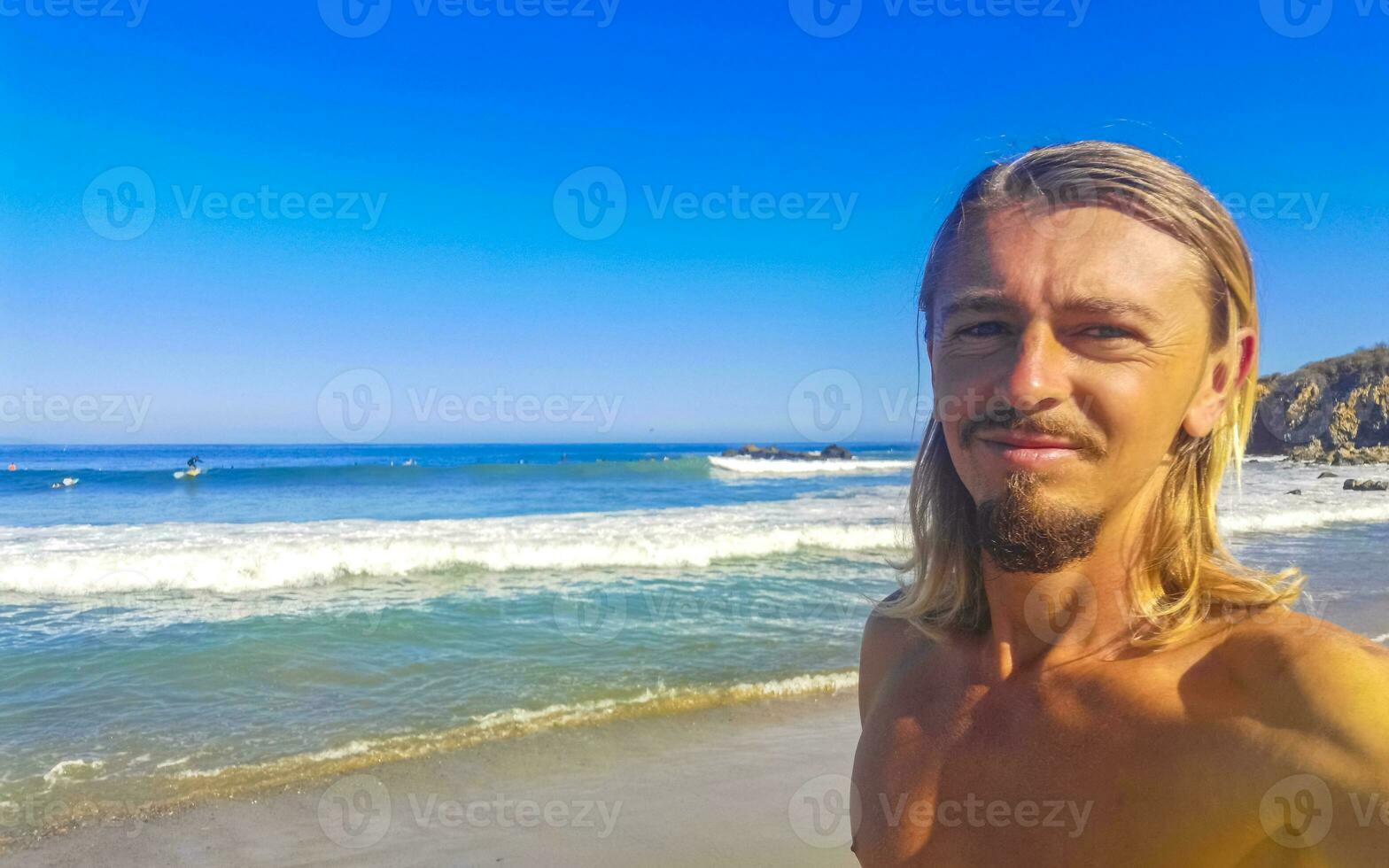 Selfie with rocks cliffs view waves beach Puerto Escondido Mexico. photo