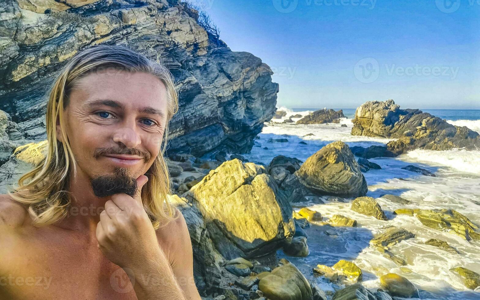 Selfie with rocks cliffs view waves beach Puerto Escondido Mexico. photo