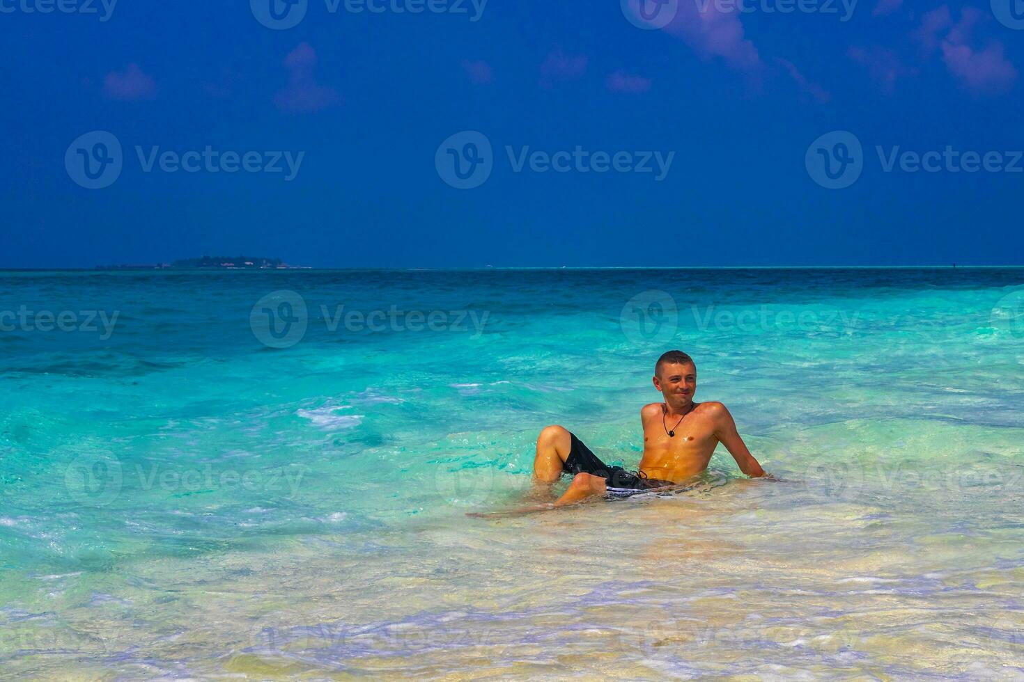 Male model tourist on island Madivaru Finolhu Rasdhoo Atoll Maldives. photo