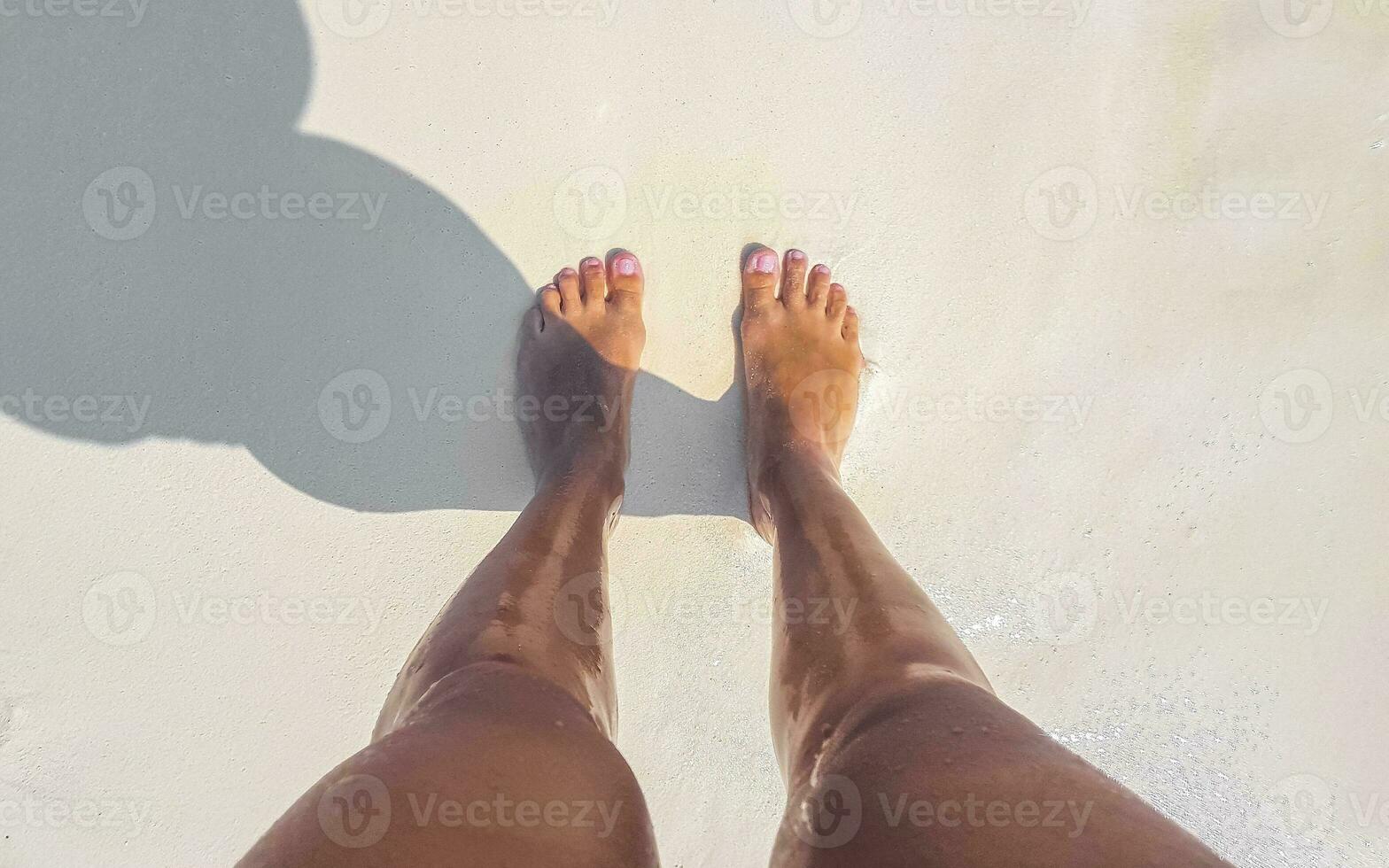 Sexy woman feet naked on the white beach sand Maldives. photo