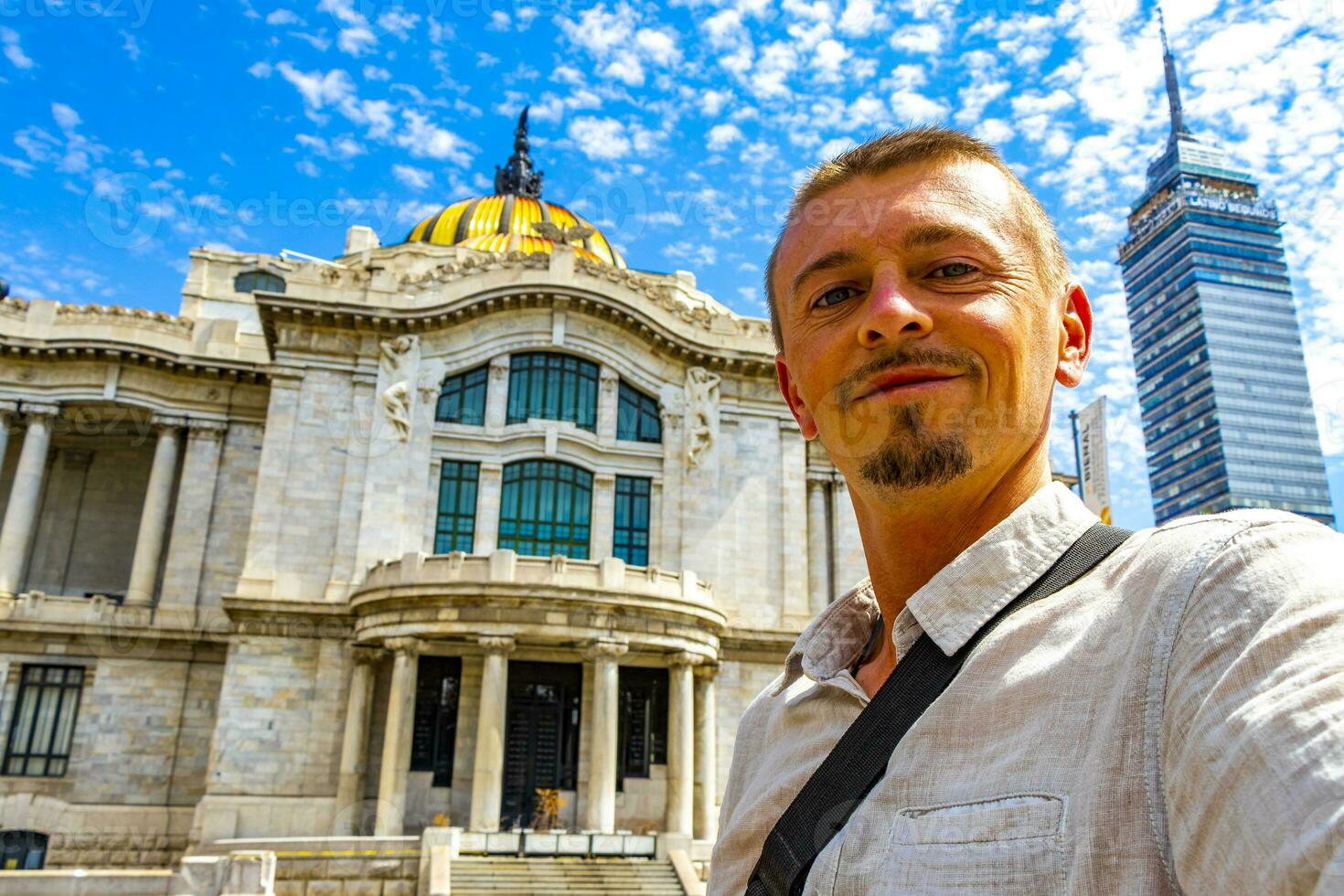 Man with selfie at fine arts architectural masterpiece Mexico City. photo