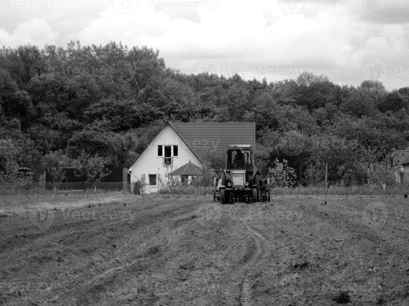 Plowed field by tractor in black soil on open countryside nature photo