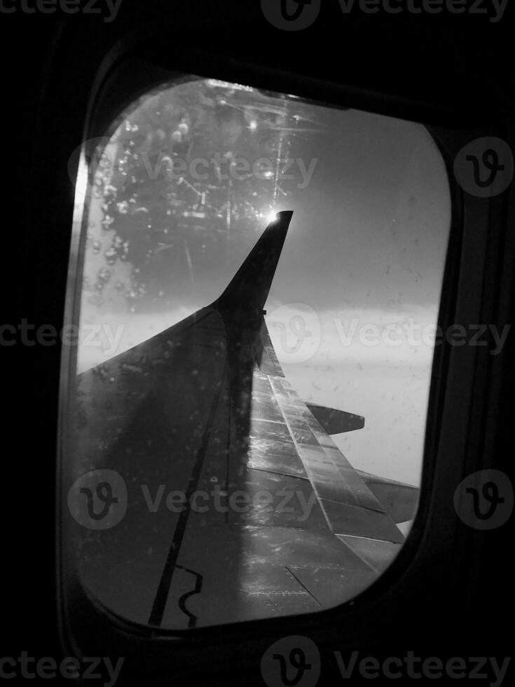 Beautiful view from airplane window, large wing of aircraft shows casement photo