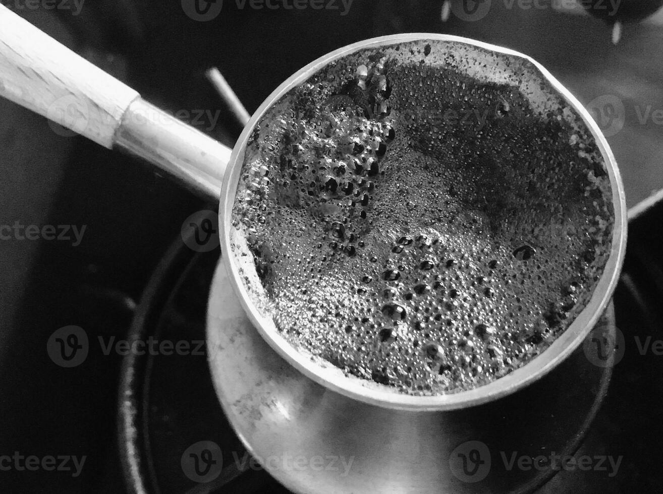 Barista preparing hot tasty drink from copper turk photo