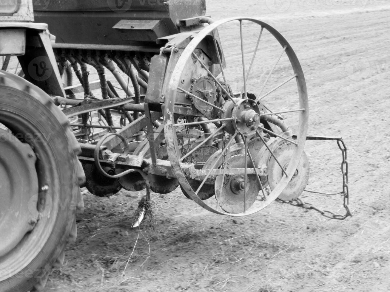 Plowed field by tractor in black soil on open countryside nature photo