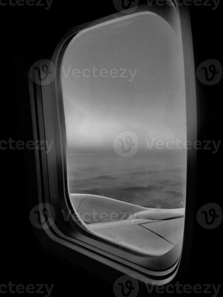 Beautiful view from airplane window, large wing of aircraft shows casement photo