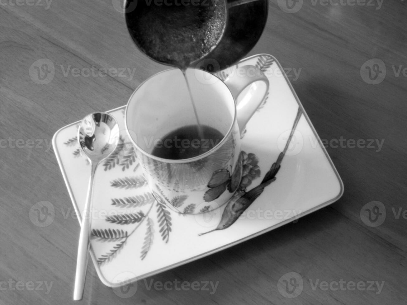 Barista preparing hot tasty drink from copper turk photo