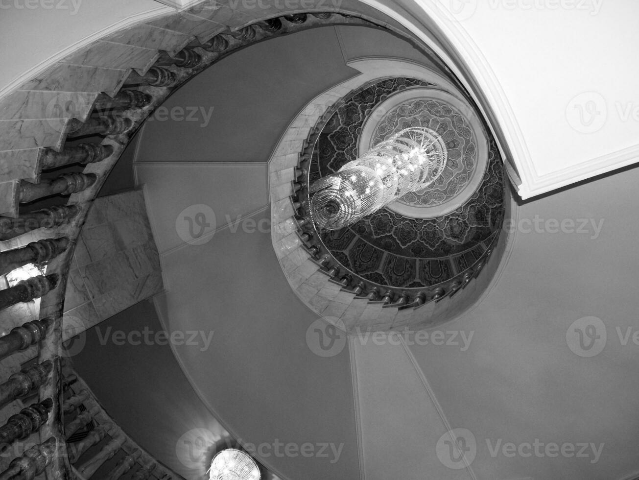 View bottom up on beautiful luxury staircase with wooden railings photo