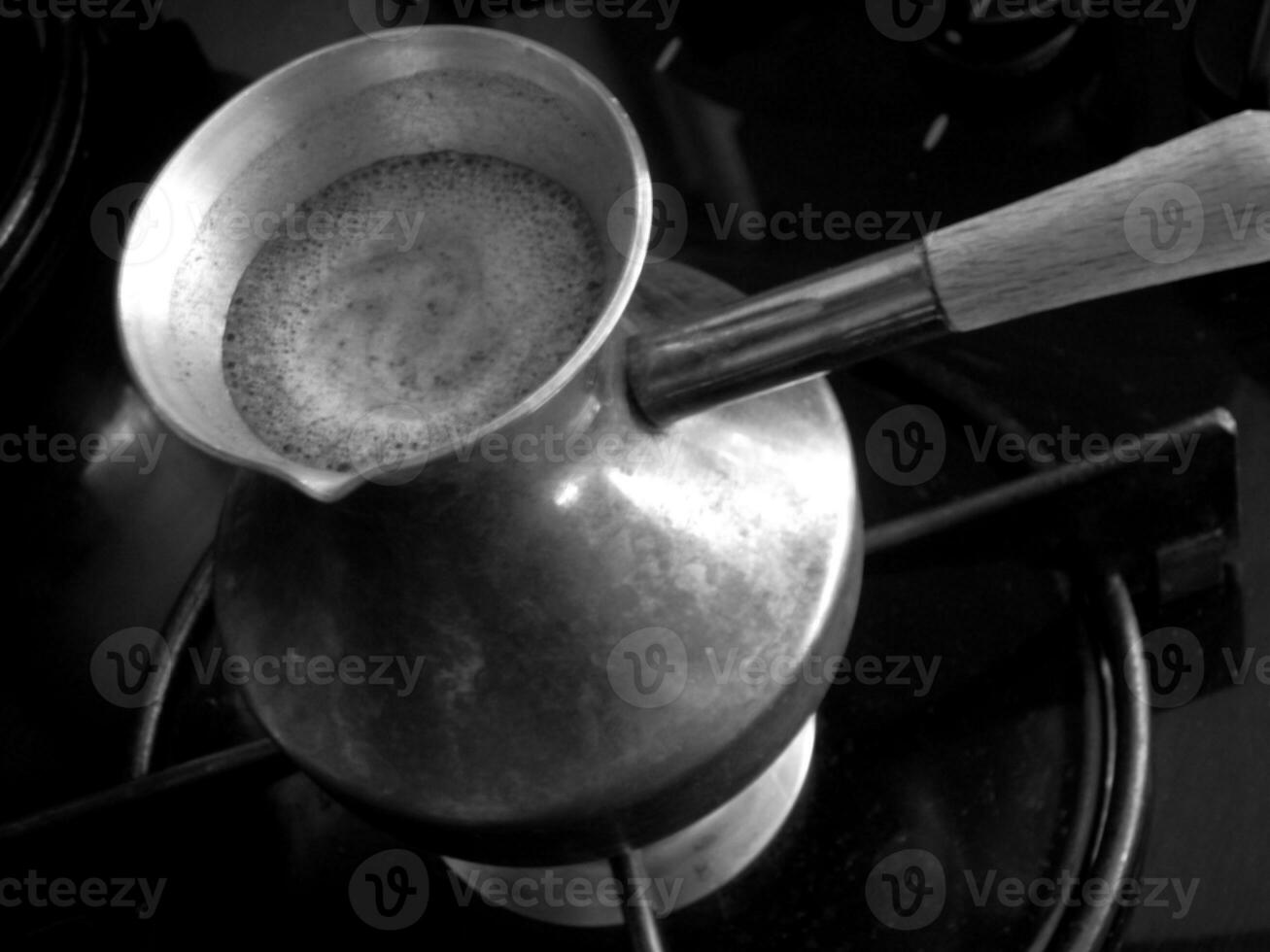 Barista preparing hot tasty drink from copper turk photo