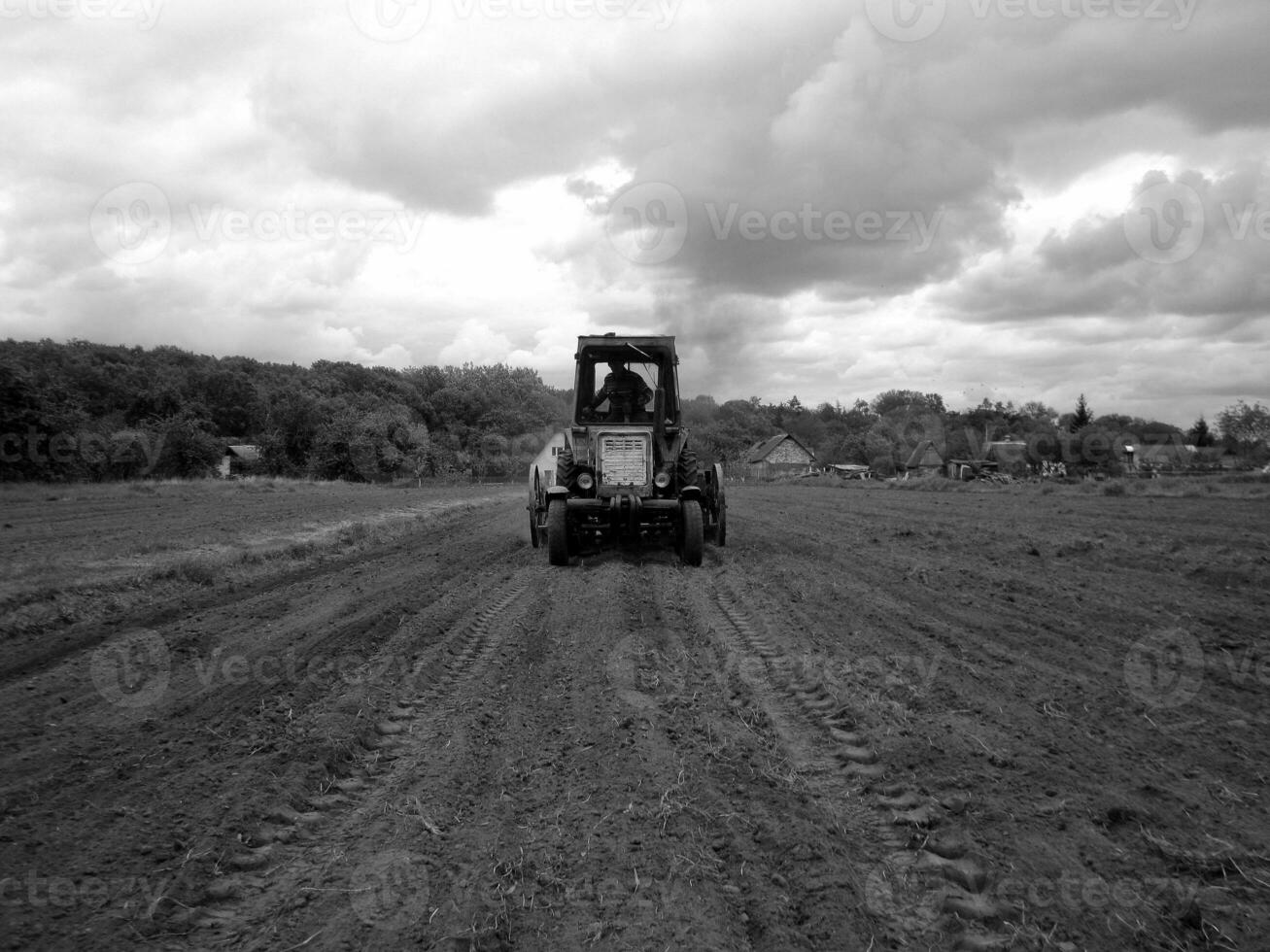 Plowed field by tractor in black soil on open countryside nature photo