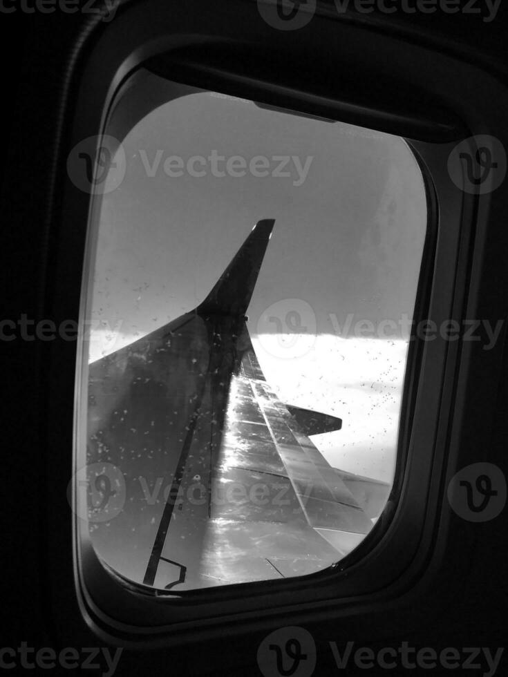 Beautiful view from airplane window, large wing of aircraft shows casement photo