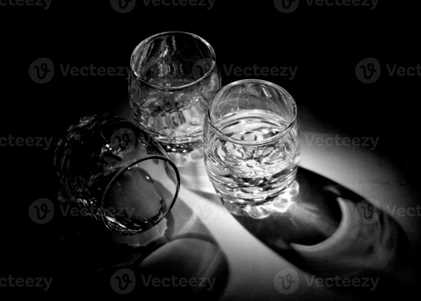 Empty shot glasses for alcoholic beverages vodka standing on wooden table photo