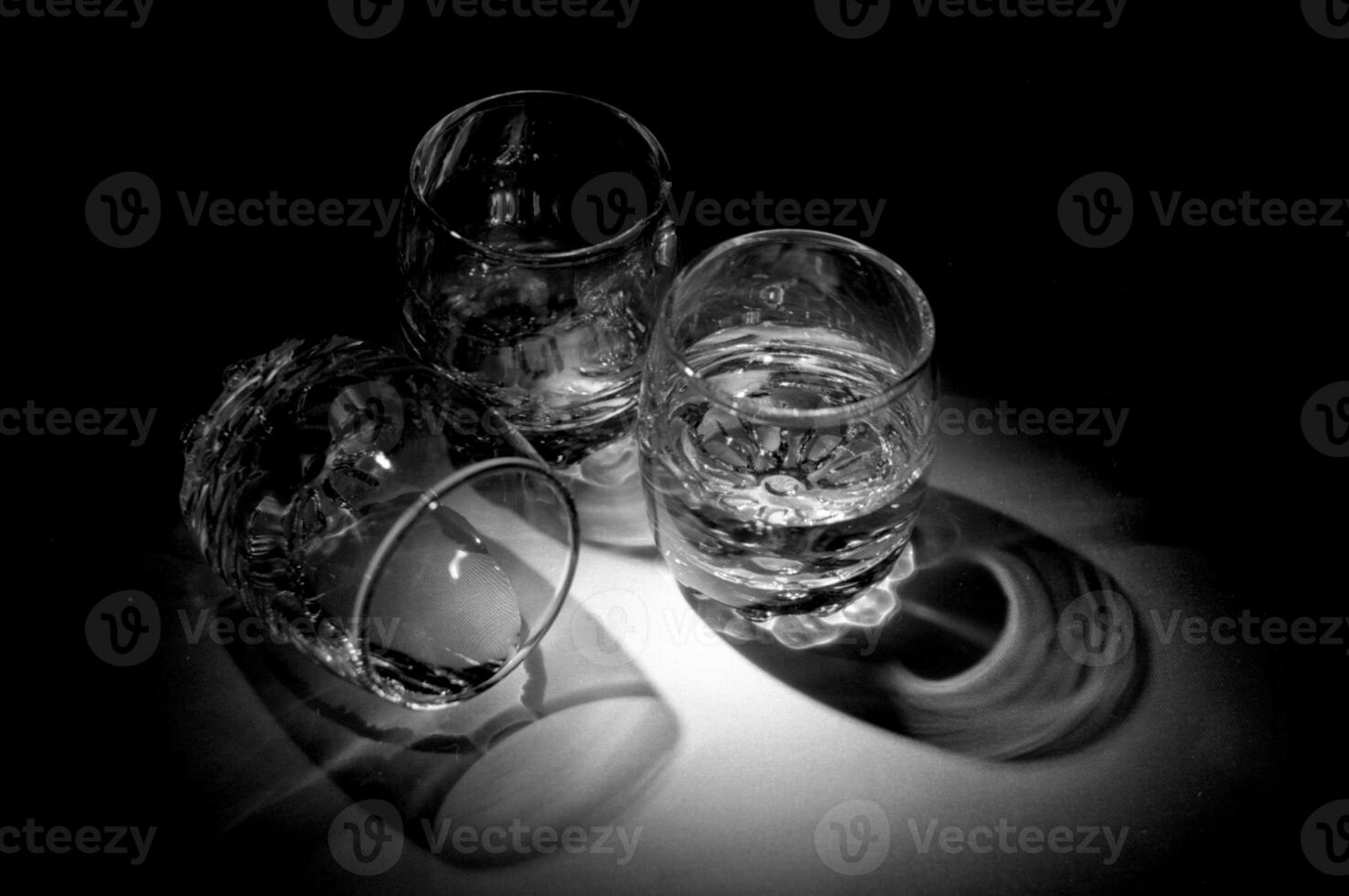 Empty shot glasses for alcoholic beverages vodka standing on wooden table photo