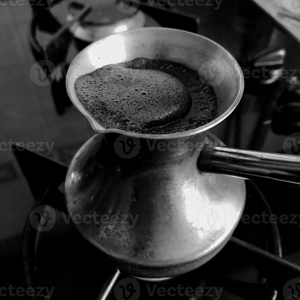 Barista preparing hot tasty drink from copper turk photo