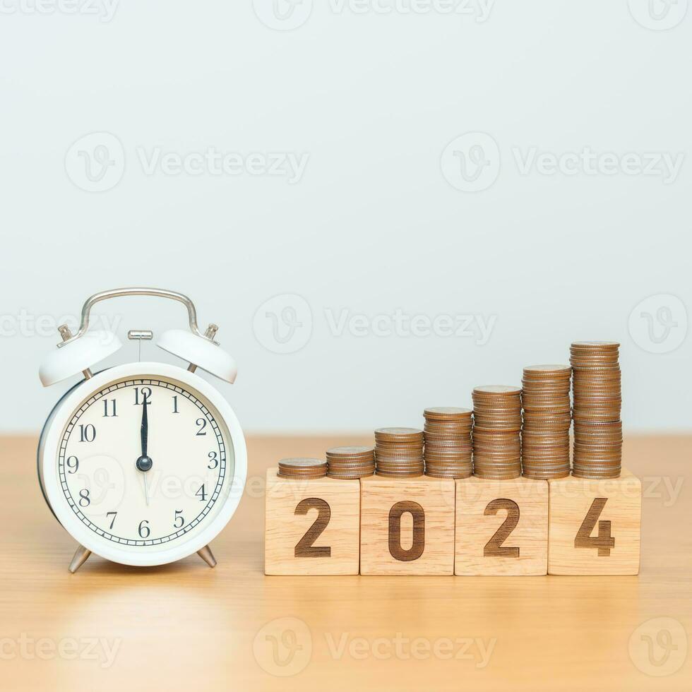 Happy New Year with vintage alarm clock and flipping 2023 change to 2024 block. Resolution, Goals, Plan, Action, Money Saving, Retirement fund, Pension, Investment and Financial concept photo