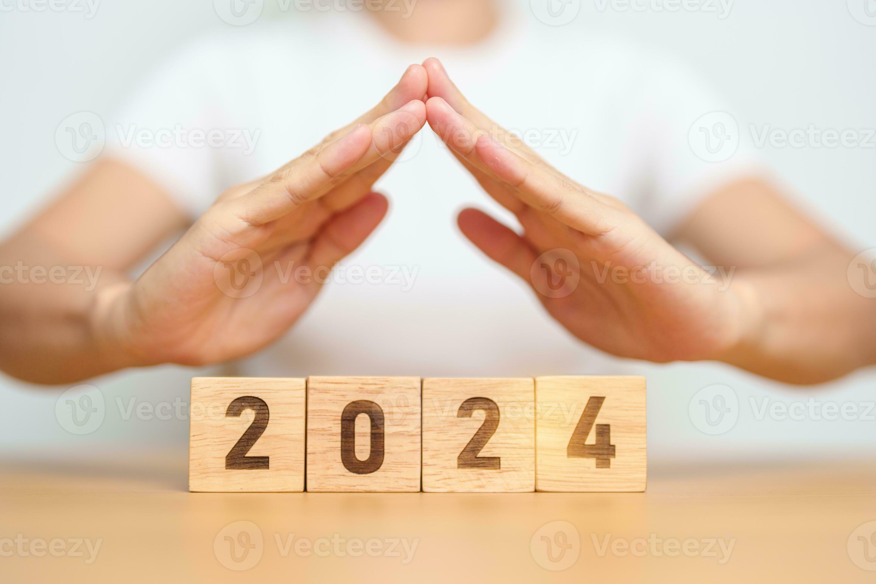 hand cover 2024 Year block. Insurance, protection, safety and New year