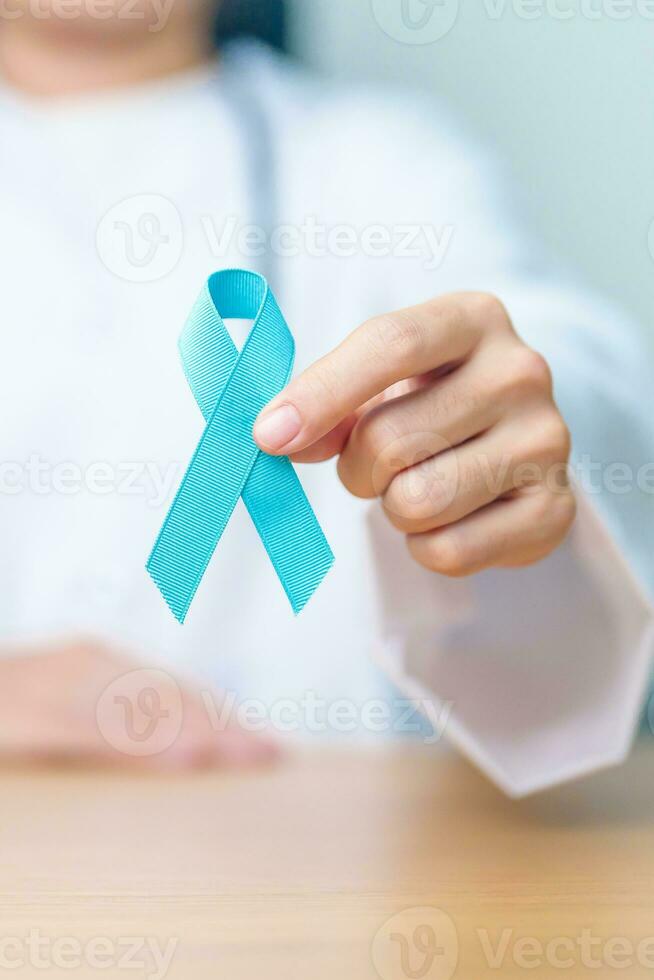 Blue November Prostate Cancer Awareness month, Doctor with Blue Ribbon in hospital for support people life and illness. Healthcare, International men, Father, Diabetes and World cancer day photo