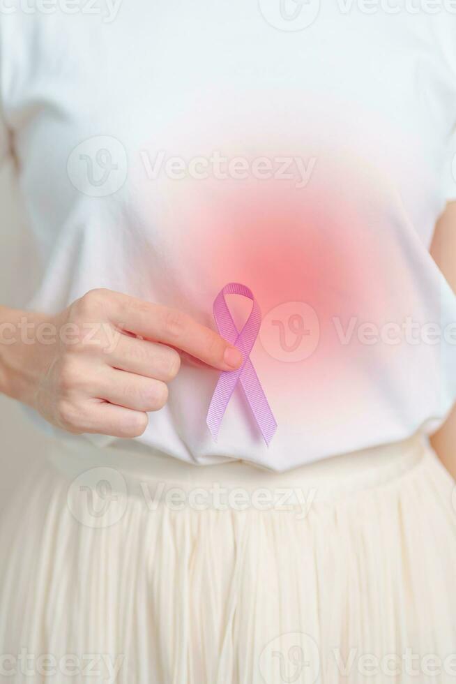 Woman having stomach and abdomen pain with Purple Ribbon for Stomach cancer Awareness month,  Digestive system, disease, health and World cancer day concept photo