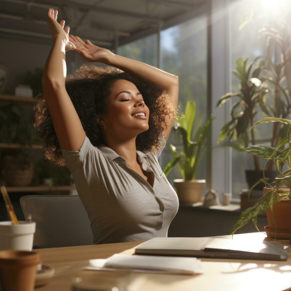 Woman stretching at desk with sunlight streaming in photo