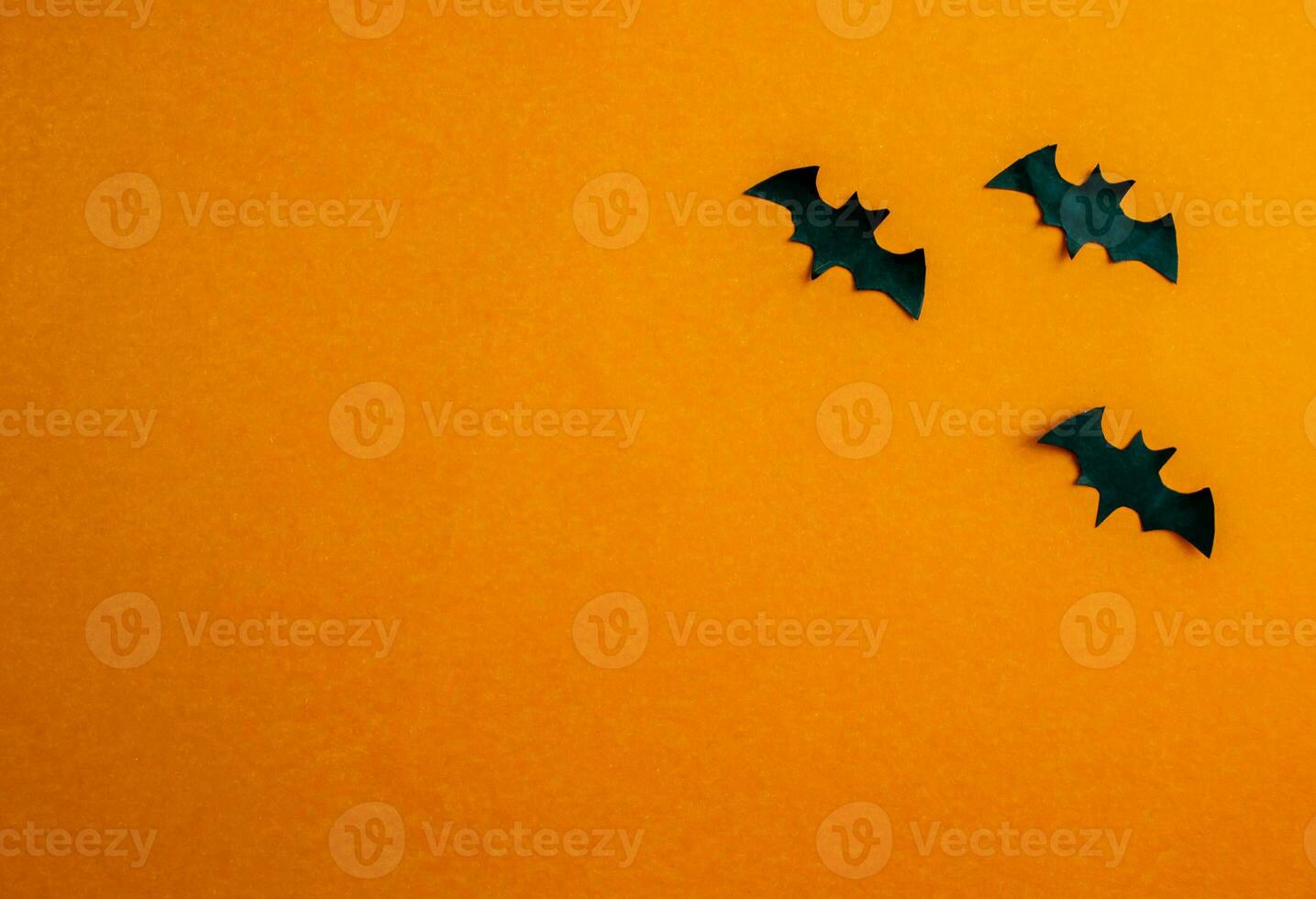 Halloween background, paper black bats on orange background. photo