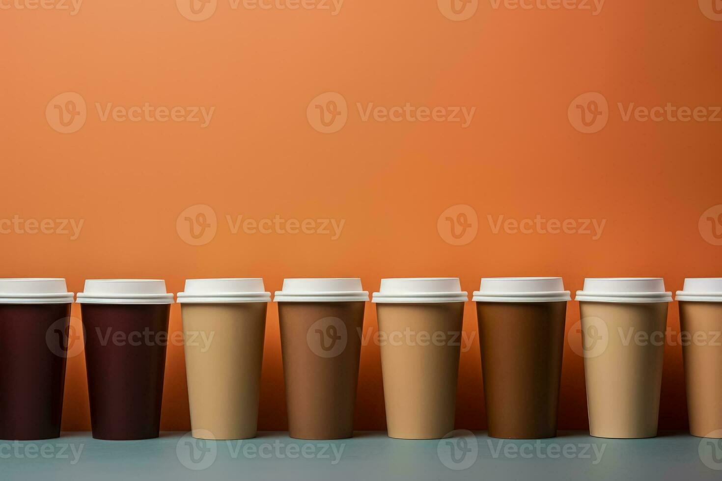 Artistic paper coffee cups lined up background with empty space for text photo