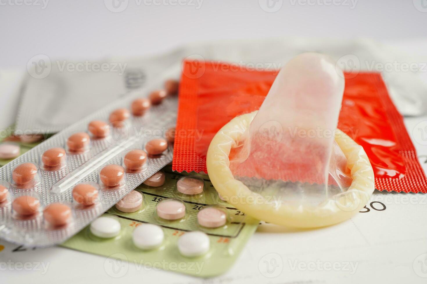 Pregnancy test with birth control pills for female on calendar, ovulation day. photo