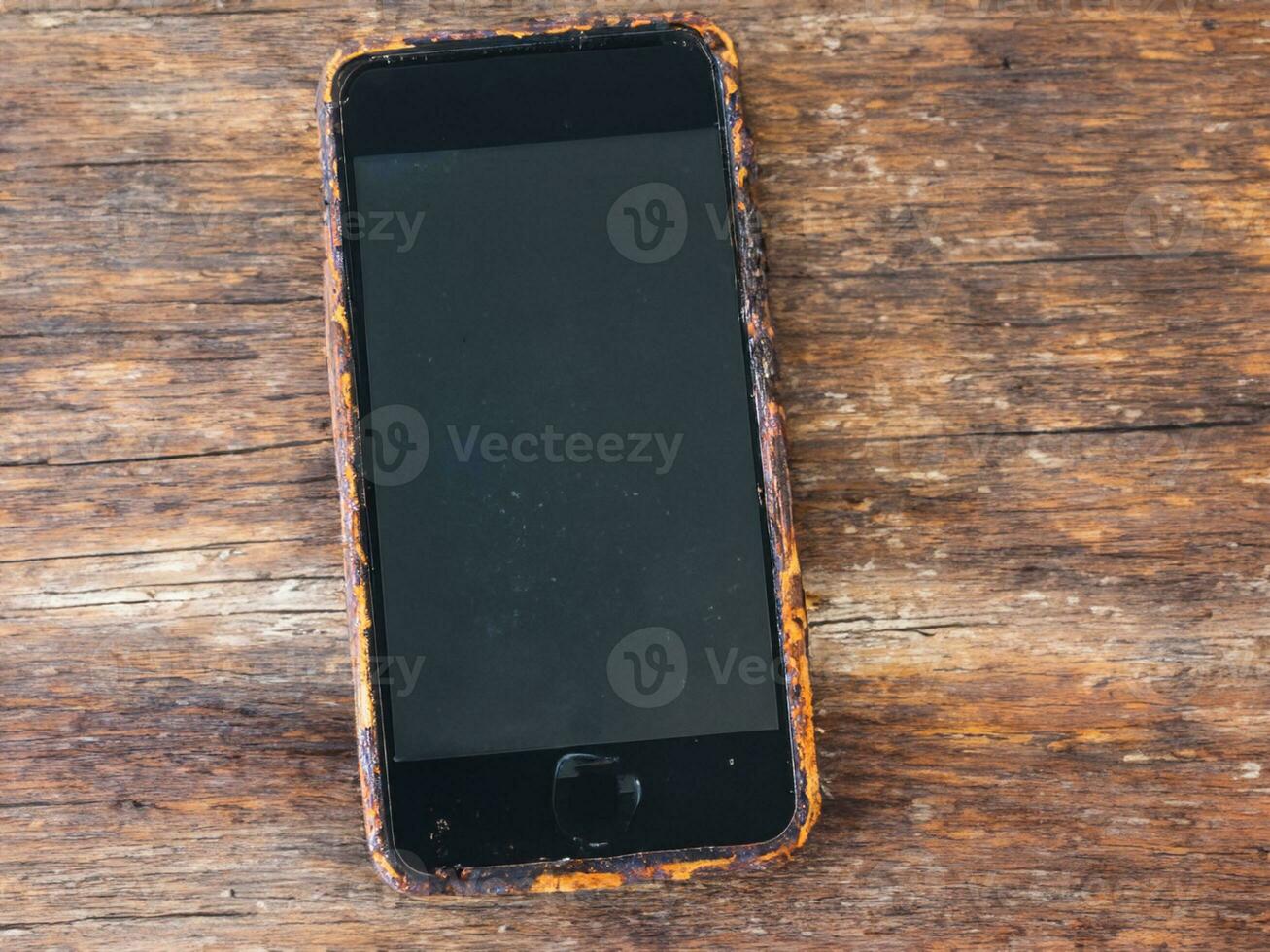 rusty old mobile phone on a wooden background photo