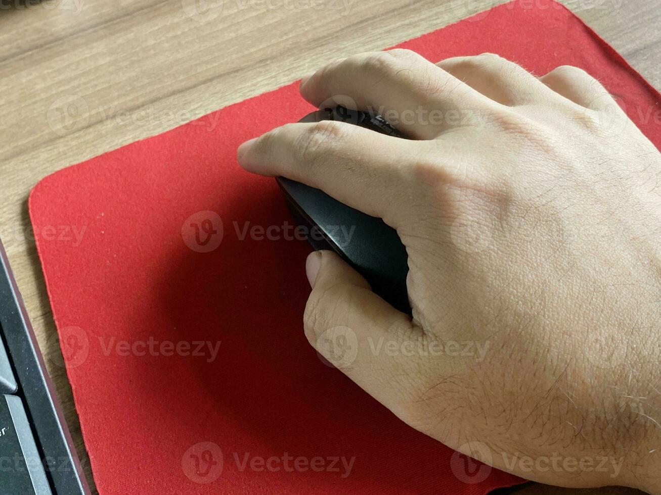 man 's hand using a laptop computer mouse photo