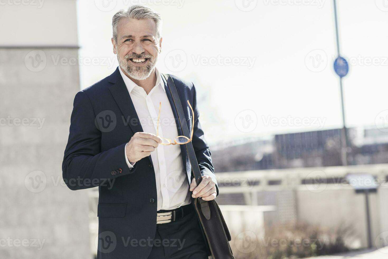 Portrait of smiling confident mature businessman outdoors photo