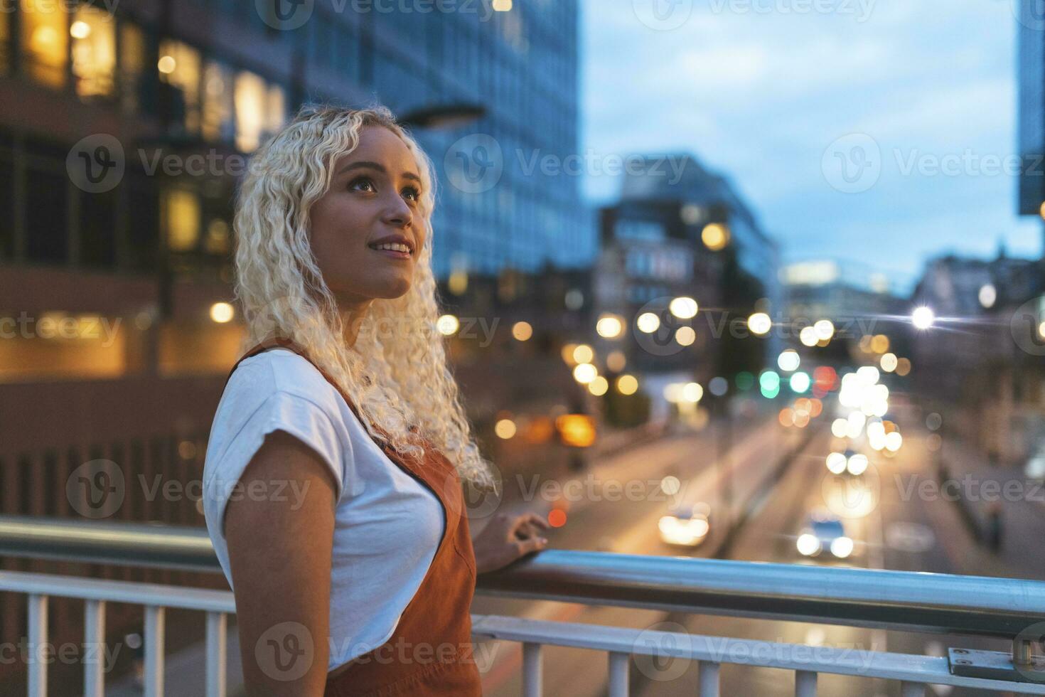 Young woman in the city at dusk with urban street in London photo