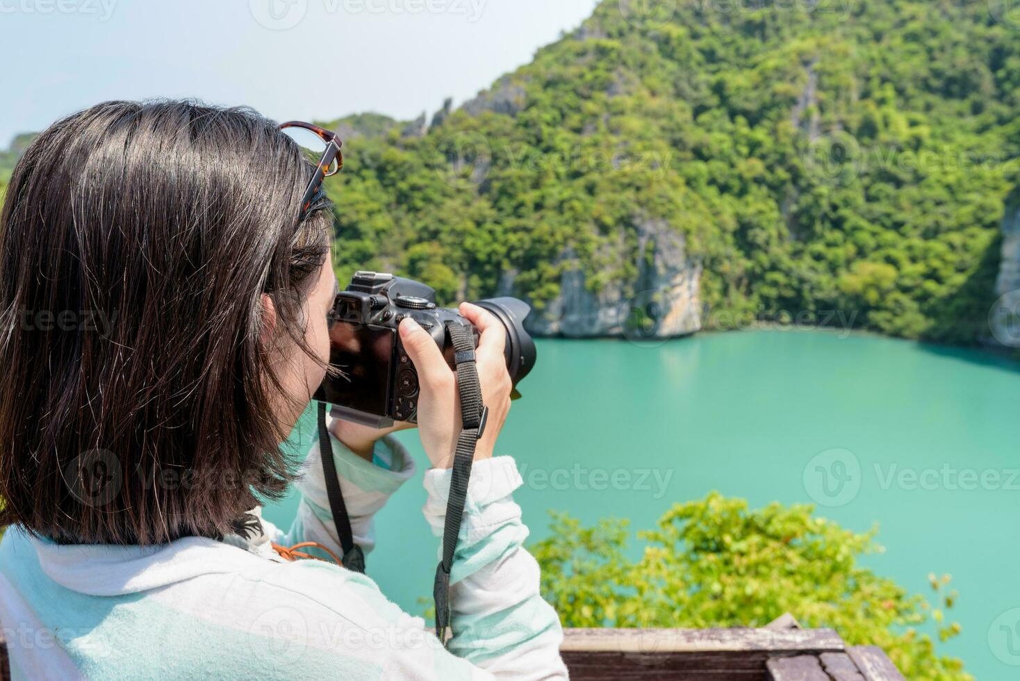 Woman tourist taking photos of Thale Nai