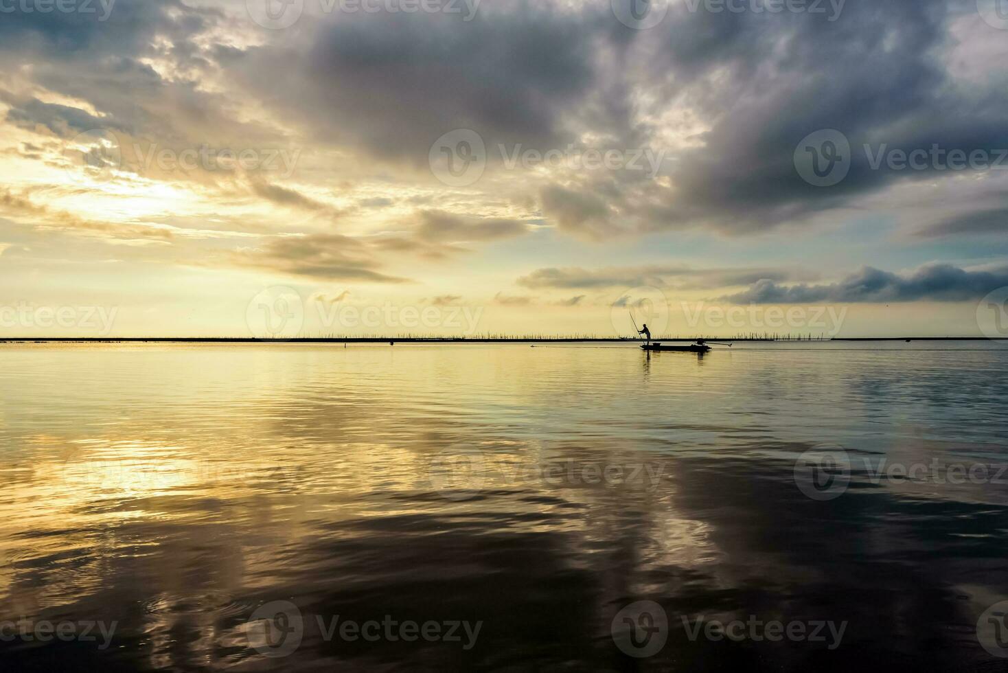 Fisherman on the boat use fishing nets at sunrise, Thailand photo
